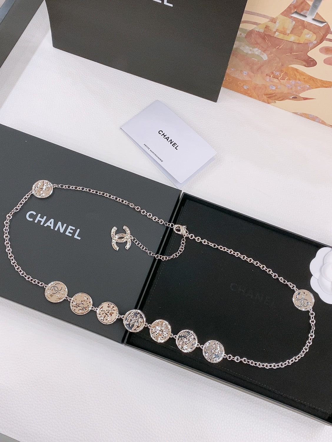 CHANEL TWISTED CHAIN BELT WITH RHINESTONES AND LOGO PLATE IN SILVER TONE