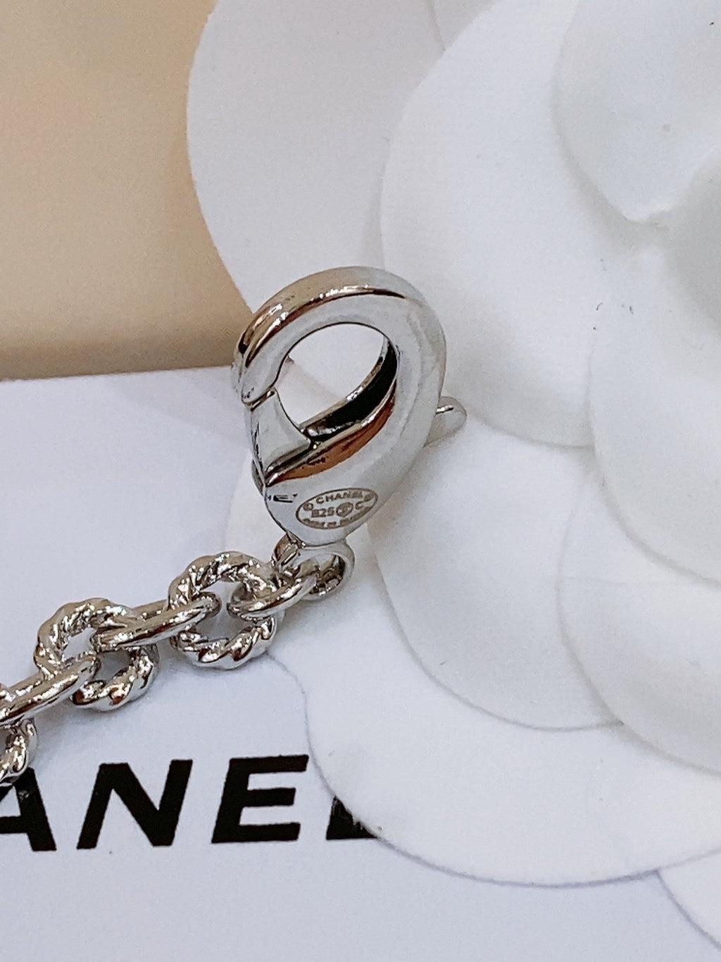 CHANEL TWISTED CHAIN BELT WITH RHINESTONES AND LOGO PLATE IN SILVER TONE